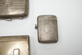 Three assorted silver cigarette cases including Art Deco, largest 10.1cm, a silver vesta case and a white metal cigarette case.